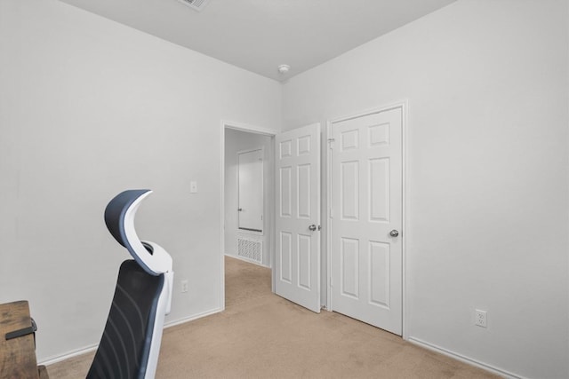 office area with light carpet and baseboards