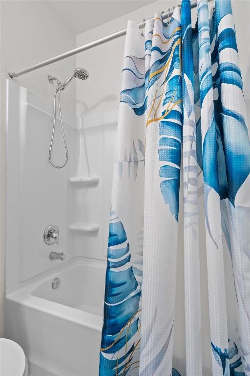 bathroom featuring shower / bathtub combination with curtain