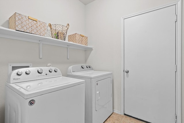 laundry area with laundry area, washing machine and dryer, and light tile patterned flooring