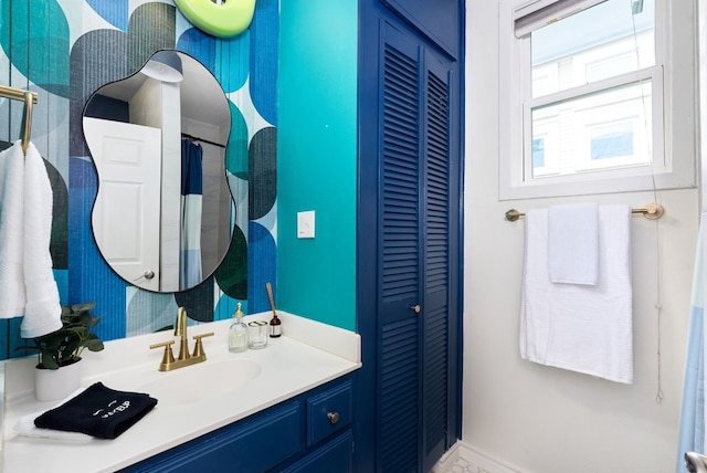 bathroom with a closet and vanity