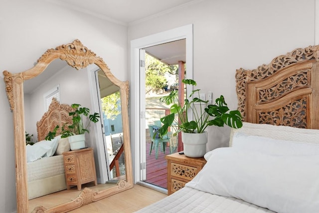 902 E Live Oak St, Austin, TX 78704 - bedroom with access to outside, multiple windows, wood finished floors, and crown molding