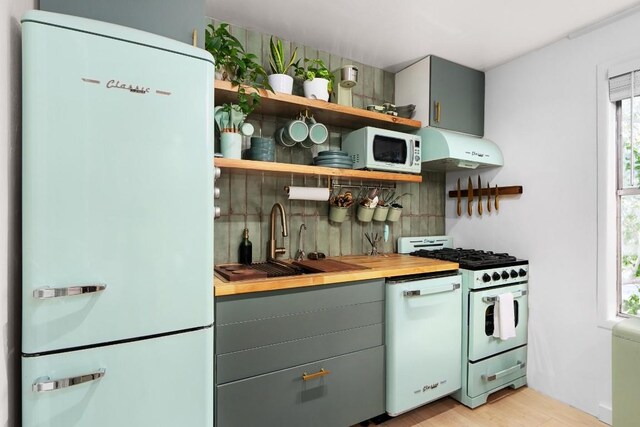 902 E Live Oak St, Austin, TX 78704 - kitchen with white appliances, extractor fan, backsplash, a sink, and open shelves