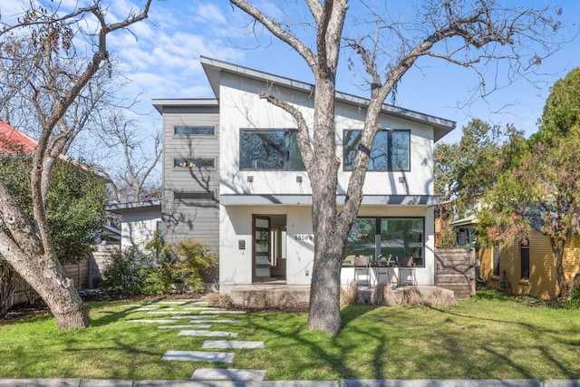 view of front of property with a front lawn and stucco siding