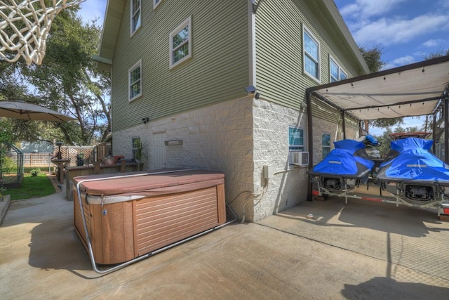 view of side of property with a hot tub and cooling unit