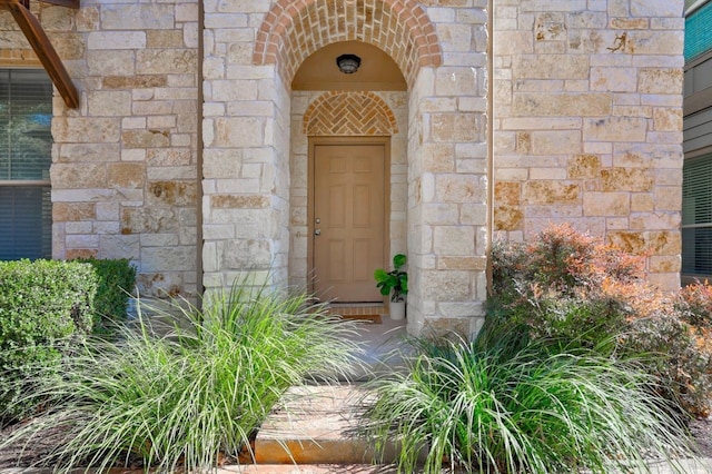 doorway to property with stone siding