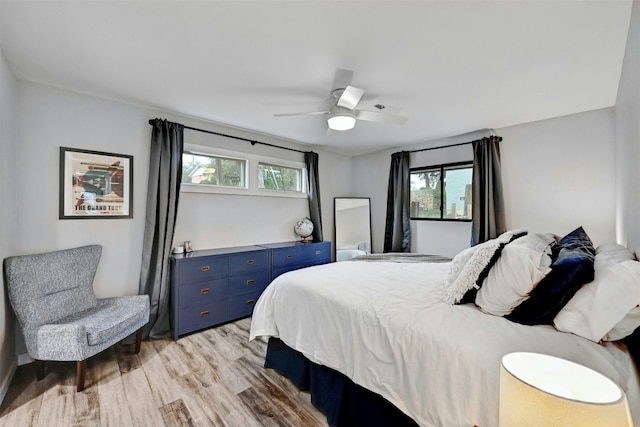 3010 Burleson Rd Unit A, Austin, TX 78741 - bedroom with multiple windows, light wood-style floors, and a ceiling fan