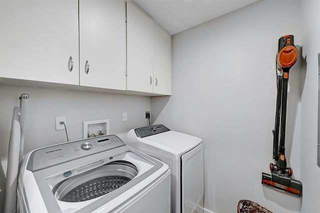 washroom with cabinet space and independent washer and dryer