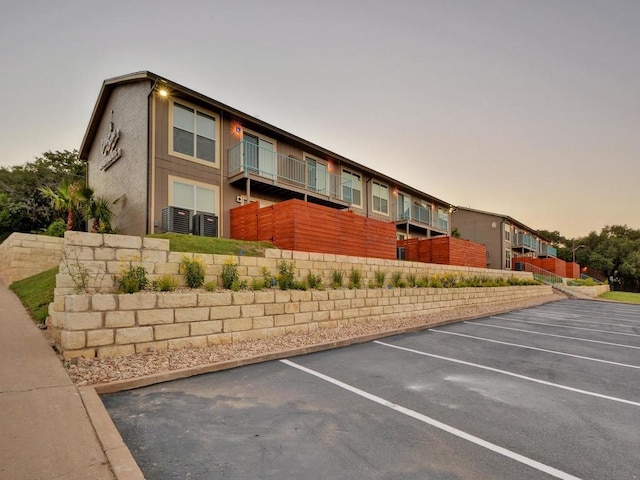 property at dusk with uncovered parking