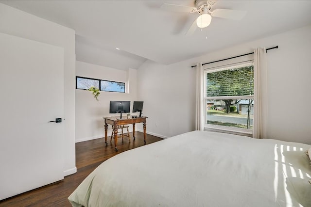 bedroom featuring dark wood-type flooring, lofted ceiling, and baseboards