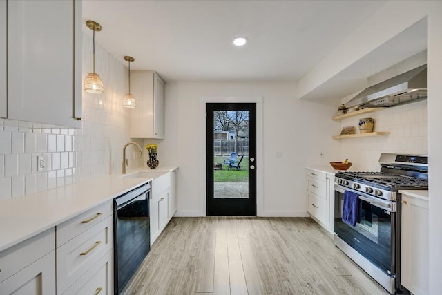 kitchen featuring white cabinets, light countertops, wall chimney range hood, stainless steel range with gas cooktop, and open shelves