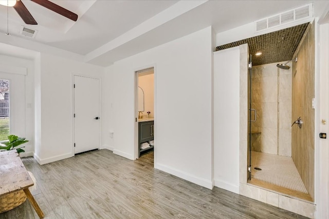 unfurnished bedroom featuring visible vents, connected bathroom, light wood-style flooring, and baseboards