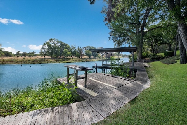 dock area with a lawn, a water view, and boat lift