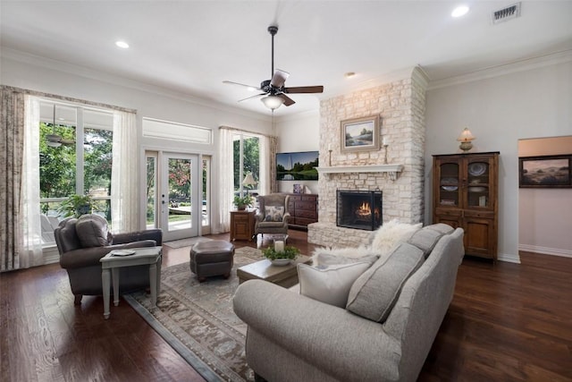 living area featuring dark wood finished floors, visible vents, and a healthy amount of sunlight