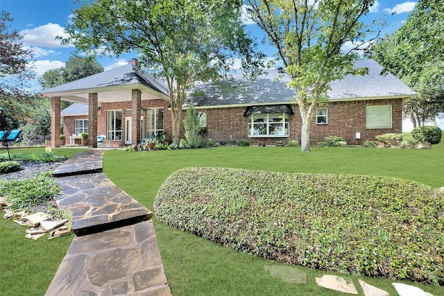 ranch-style house with brick siding and a front lawn