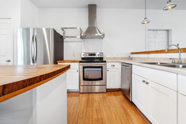 826 Savannah Cv, Elgin, TX 78621 - kitchen featuring stainless steel appliances, wall chimney exhaust hood, a sink, and white cabinets
