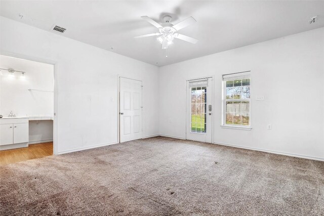 826 Savannah Cv, Elgin, TX 78621 - unfurnished bedroom featuring light carpet, access to exterior, ensuite bath, and baseboards