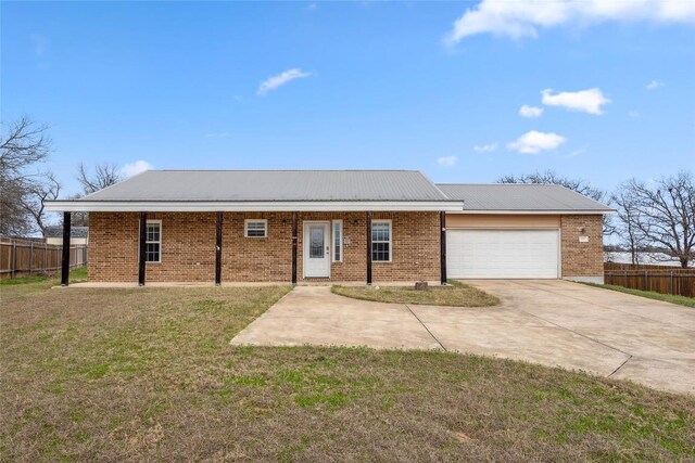 826 Savannah Cv, Elgin, TX 78621 - single story home with driveway, an attached garage, brick siding, and metal roof