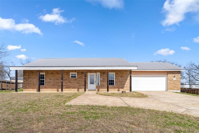 826 Savannah Cv, Elgin, TX 78621 - view of front of house with brick siding, a garage, concrete driveway, and metal roof