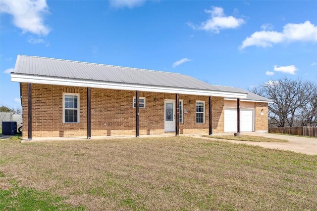 826 Savannah Cv, Elgin, TX 78621 - ranch-style house with a garage, brick siding, driveway, central AC unit, and metal roof