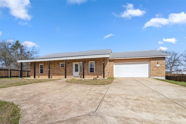 826 Savannah Cv, Elgin, TX 78621 - ranch-style house featuring concrete driveway, brick siding, an attached garage, and metal roof