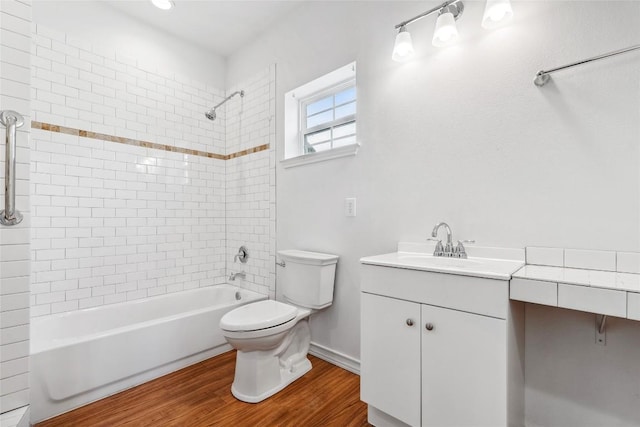 826 Savannah Cv, Elgin, TX 78621 - bathroom featuring toilet, vanity, washtub / shower combination, wood finished floors, and baseboards