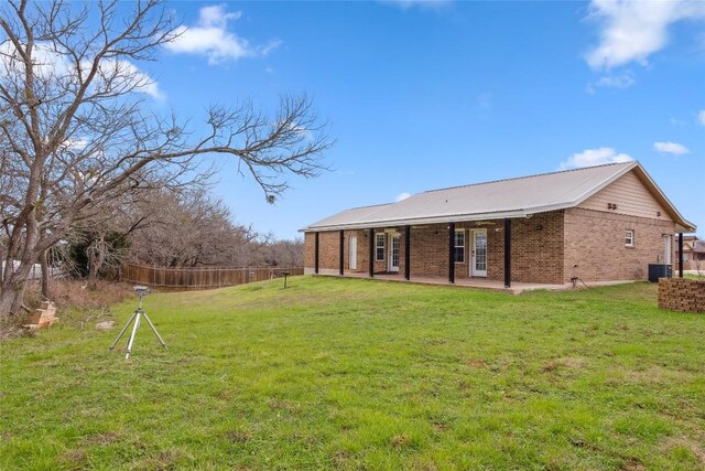 826 Savannah Cv, Elgin, TX 78621 - back of property with central AC unit, a patio area, and brick siding