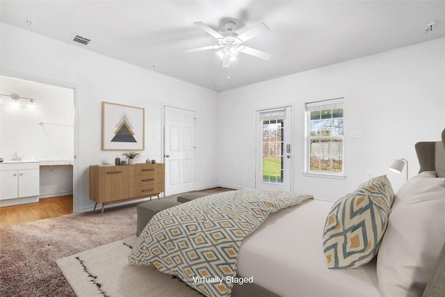 826 Savannah Cv, Elgin, TX 78621 - bedroom featuring connected bathroom, a ceiling fan, light carpet, and baseboards