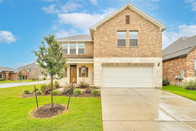 traditional-style house with a garage, a front yard, concrete driveway, and brick siding