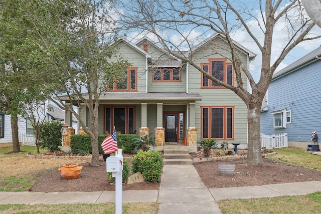 craftsman inspired home with covered porch and fence