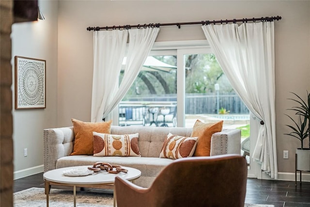 living area featuring dark wood finished floors and baseboards