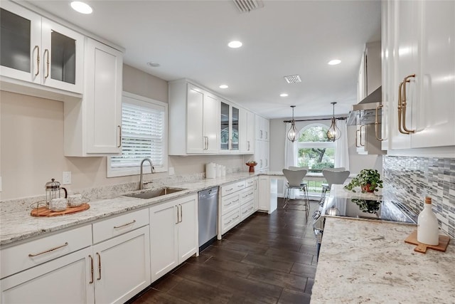 kitchen with stainless steel dishwasher, a sink, glass insert cabinets, and white cabinetry