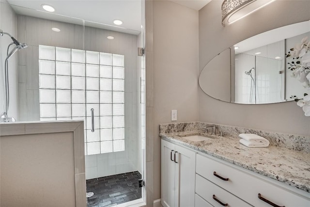 full bath with a shower stall, vanity, and recessed lighting