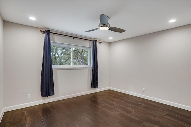 spare room with recessed lighting, dark wood-style flooring, ceiling fan, and baseboards