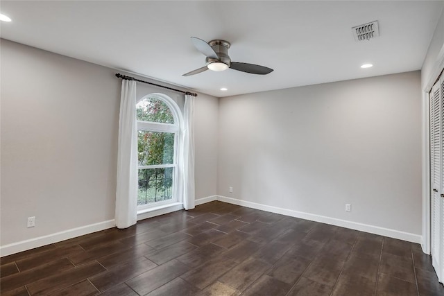 unfurnished room with recessed lighting, a ceiling fan, visible vents, baseboards, and dark wood finished floors