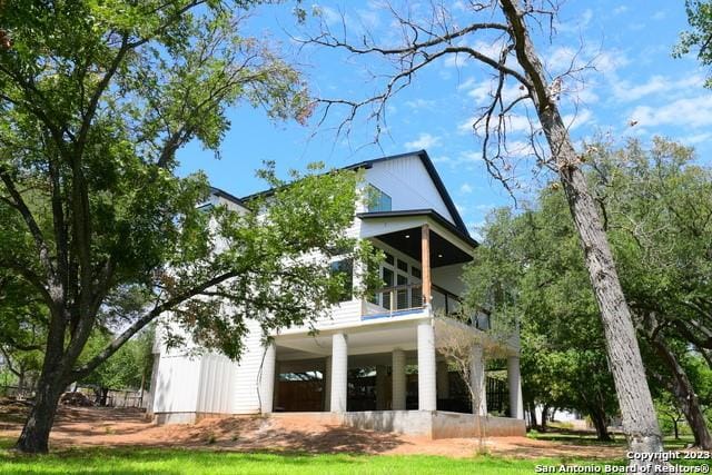 back of property featuring a balcony