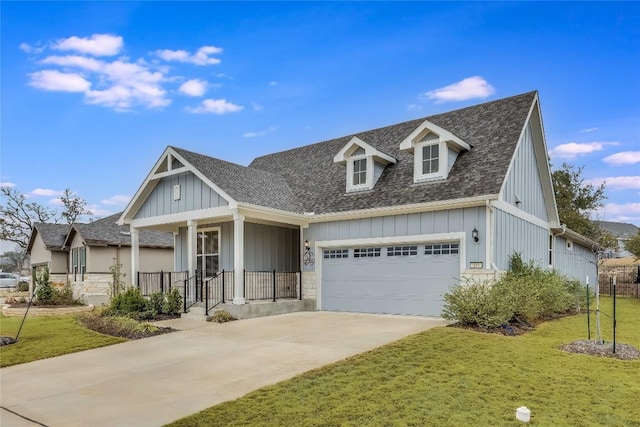331 Kitty Hawk Rd, Georgetown, TX 78633 - view of front of house with a front yard, driveway, a garage, roof with shingles, and board and batten siding