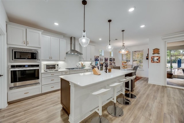 331 Kitty Hawk Rd, Georgetown, TX 78633 - kitchen featuring stainless steel appliances, wall chimney range hood, light countertops, tasteful backsplash, and recessed lighting
