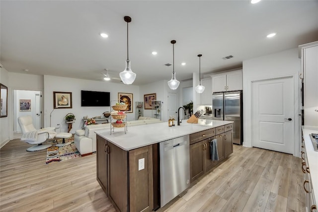 331 Kitty Hawk Rd, Georgetown, TX 78633 - kitchen featuring stainless steel appliances, light wood-style flooring, open floor plan, light countertops, and recessed lighting