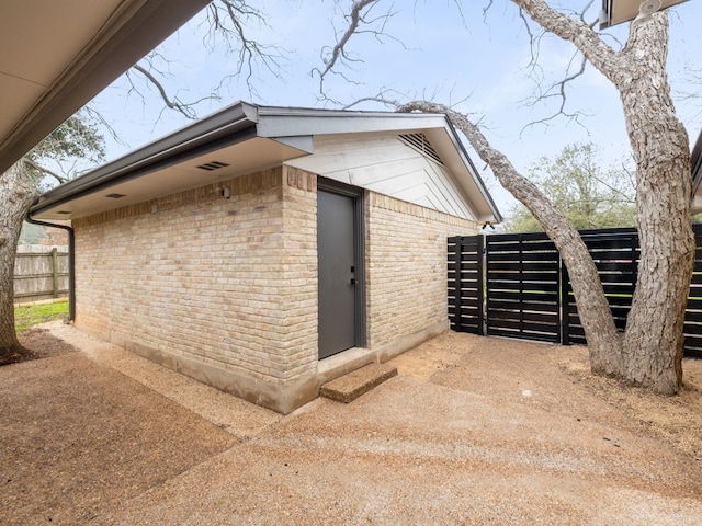 8205 Alabama Dr, Austin, TX 78745 - view of home's exterior with brick siding and an outbuilding