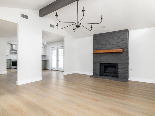 8205 Alabama Dr, Austin, TX 78745 - unfurnished living room featuring a chandelier, light wood-style floors, and a fireplace