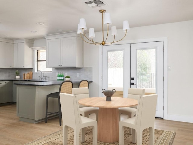 8205 Alabama Dr, Austin, TX 78745 - dining room featuring a chandelier and light wood-style floors