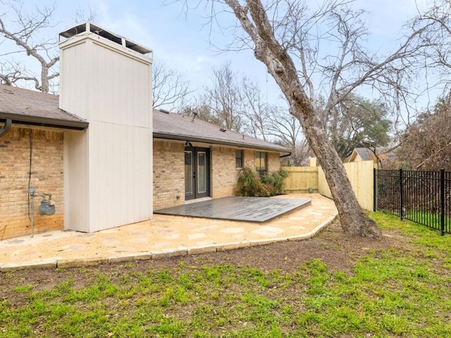8205 Alabama Dr, Austin, TX 78745 - back of property featuring a patio, brick siding, roof with shingles, and a chimney