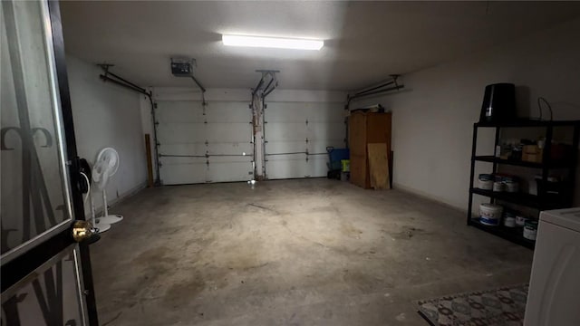 garage featuring washer / dryer and a garage door opener