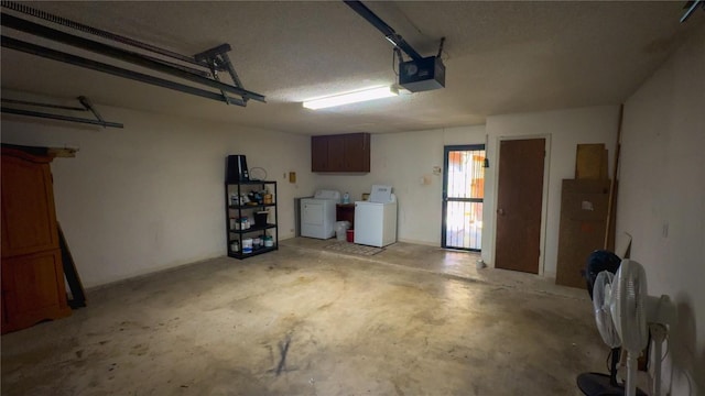 garage with a garage door opener and washer and dryer