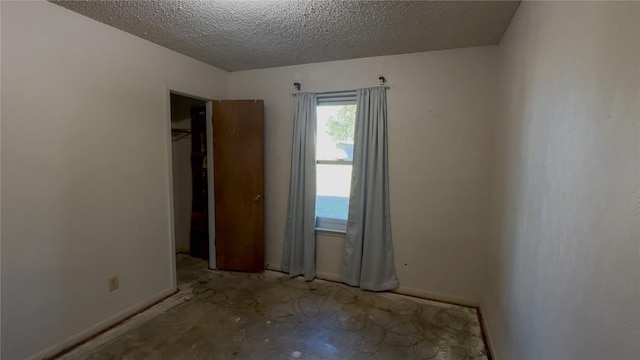 empty room with a textured ceiling