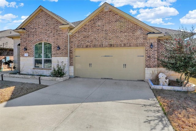 view of front of home featuring driveway, a garage, and brick siding