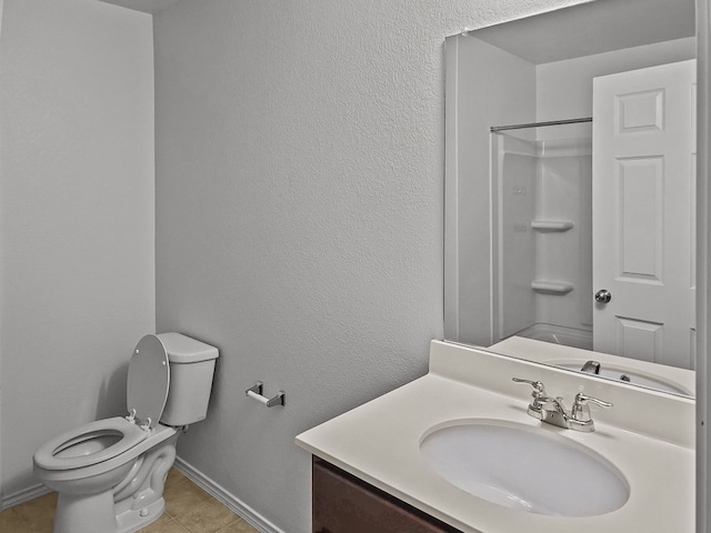 bathroom with baseboards, a shower, a textured wall, toilet, and vanity