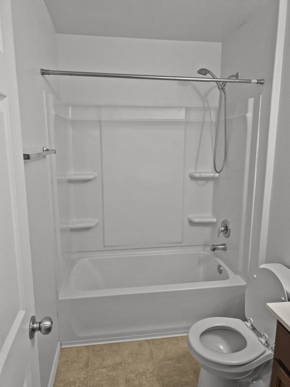 bathroom featuring tile patterned flooring, toilet, vanity, and shower / tub combination