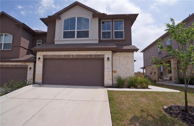 view of front facade featuring an attached garage, stone siding, driveway, stucco siding, and a front lawn