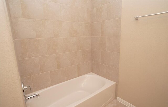 409 Epiphany Ln, Pflugerville, TX 78660 - bathroom featuring baseboards and  shower combination